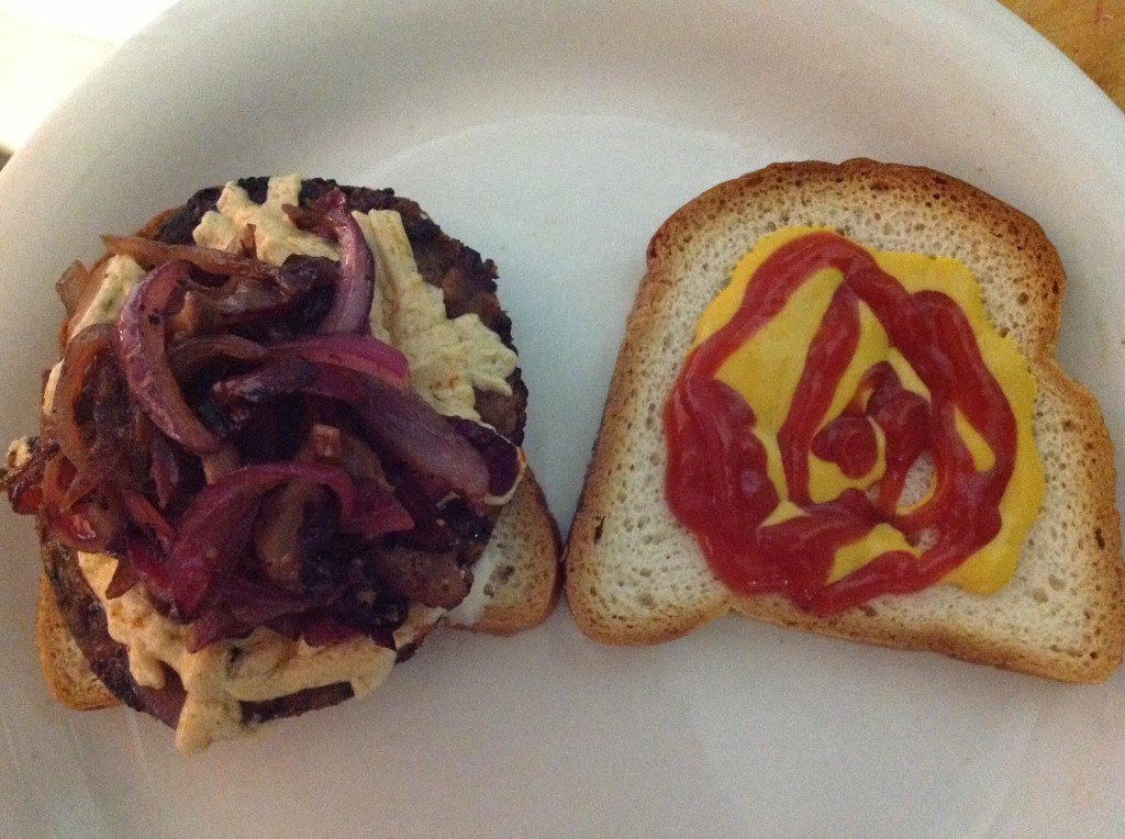 Eggplant burger with grilled shiitake mushrooms, onions and vegan cheese on gluten free bread